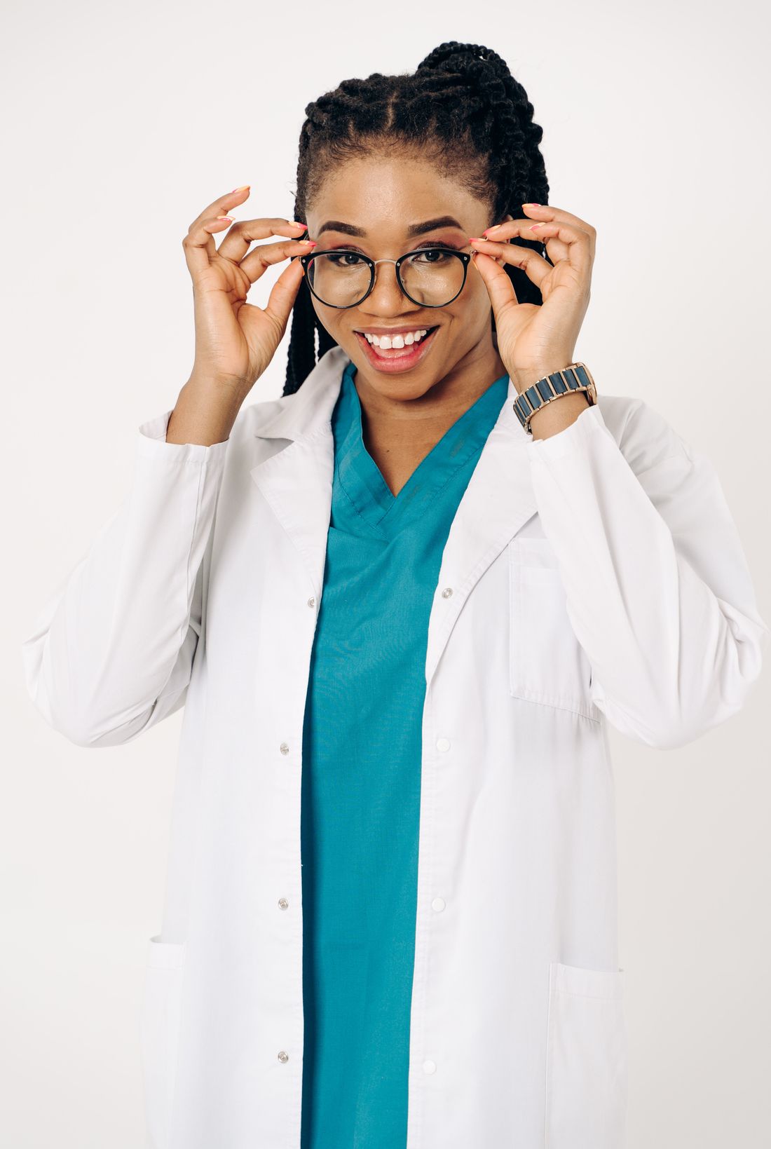 Studio portrait of a smiling healthcare provider in a white coat, illustrating a credible and approachable headshot expression