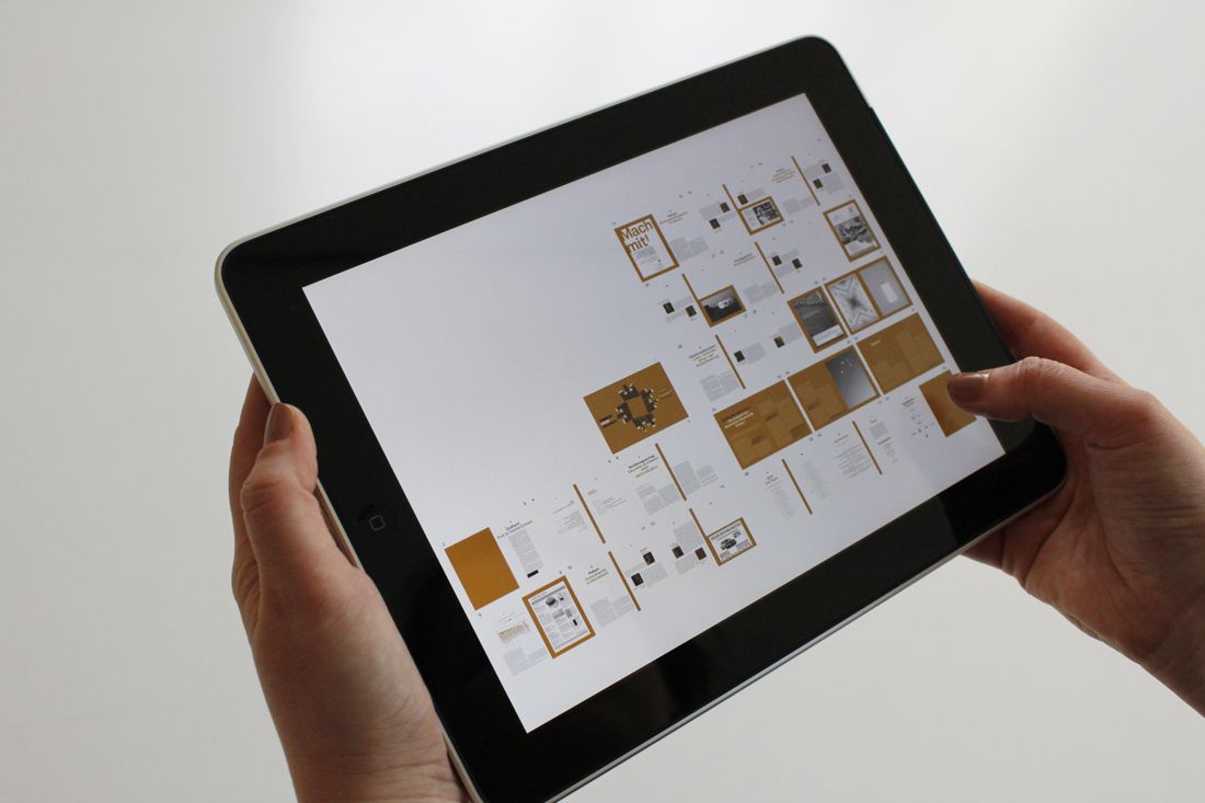 Close-up of hands using a tablet displaying a digital interface