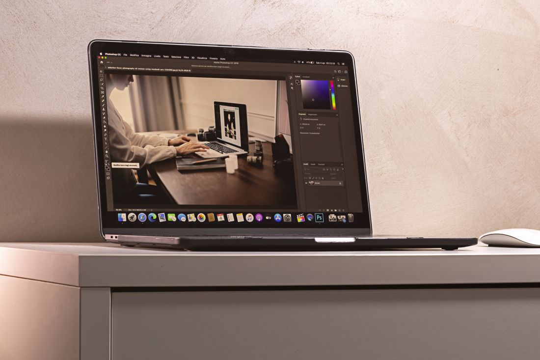 Laptop displaying a photo editing software interface on a clean desk setup