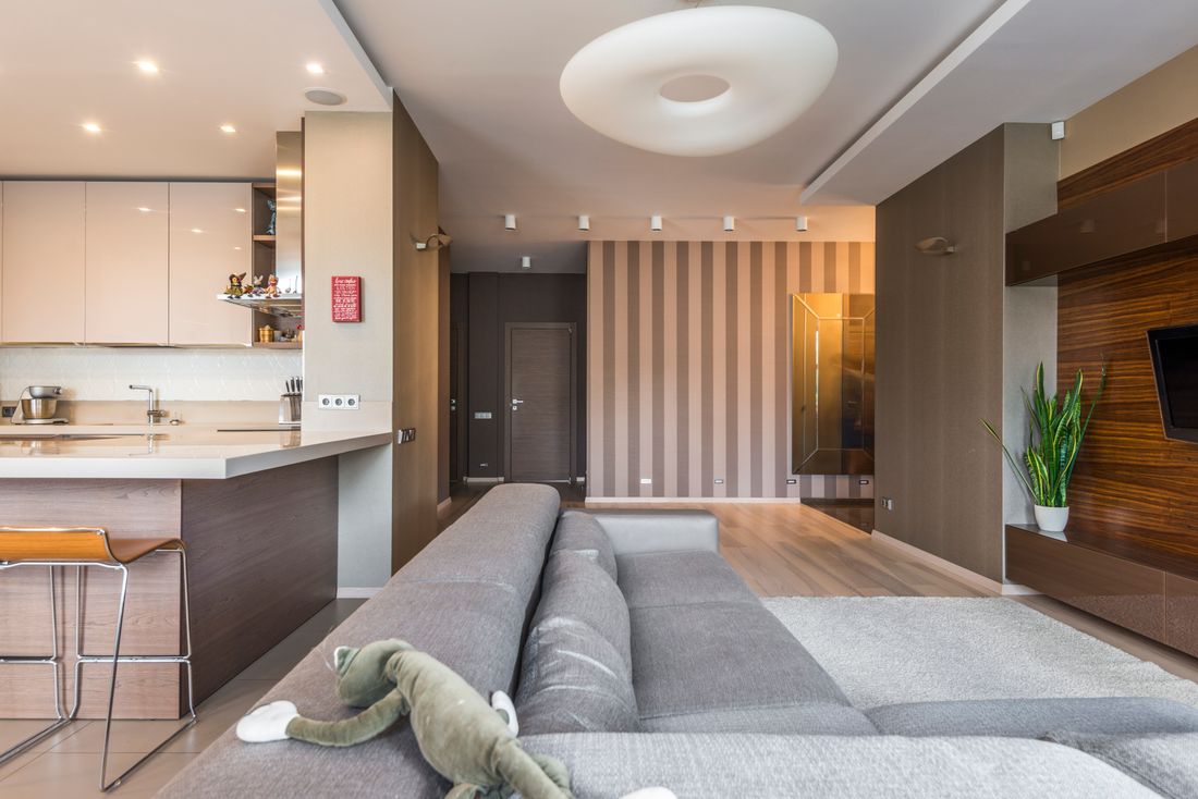 Bright modern open-plan kitchen and living room interior with clean lines and natural light