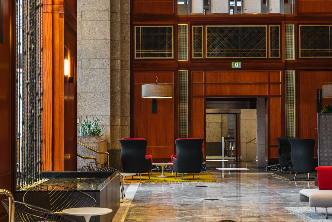 Contemporary office atrium with refreshed modern interior design and seating.