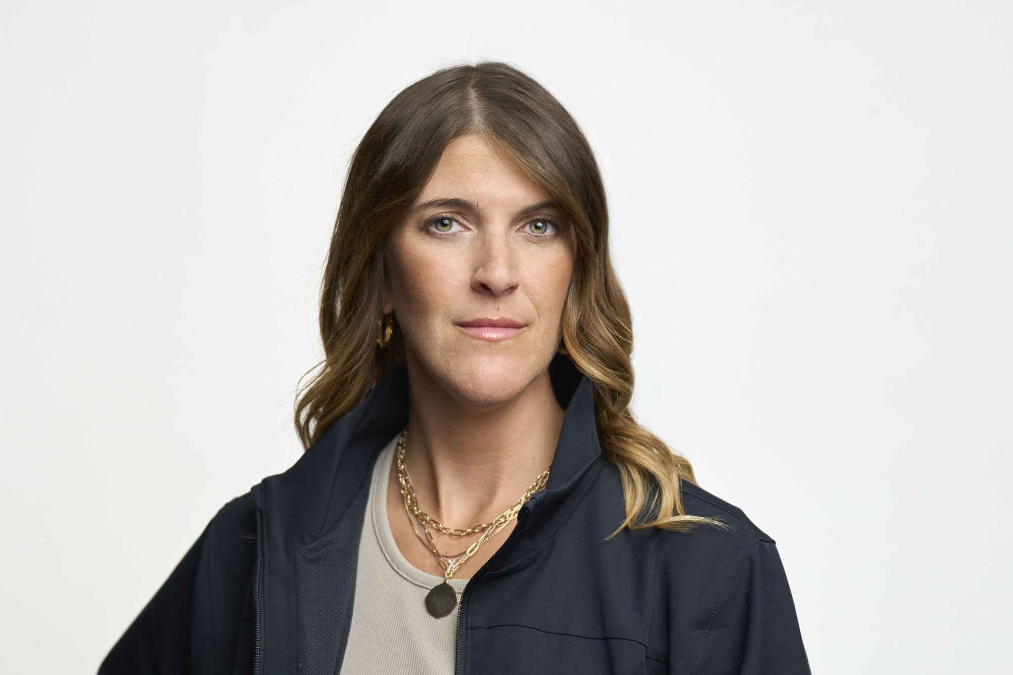Professional woman with wavy hair in dark jacket
