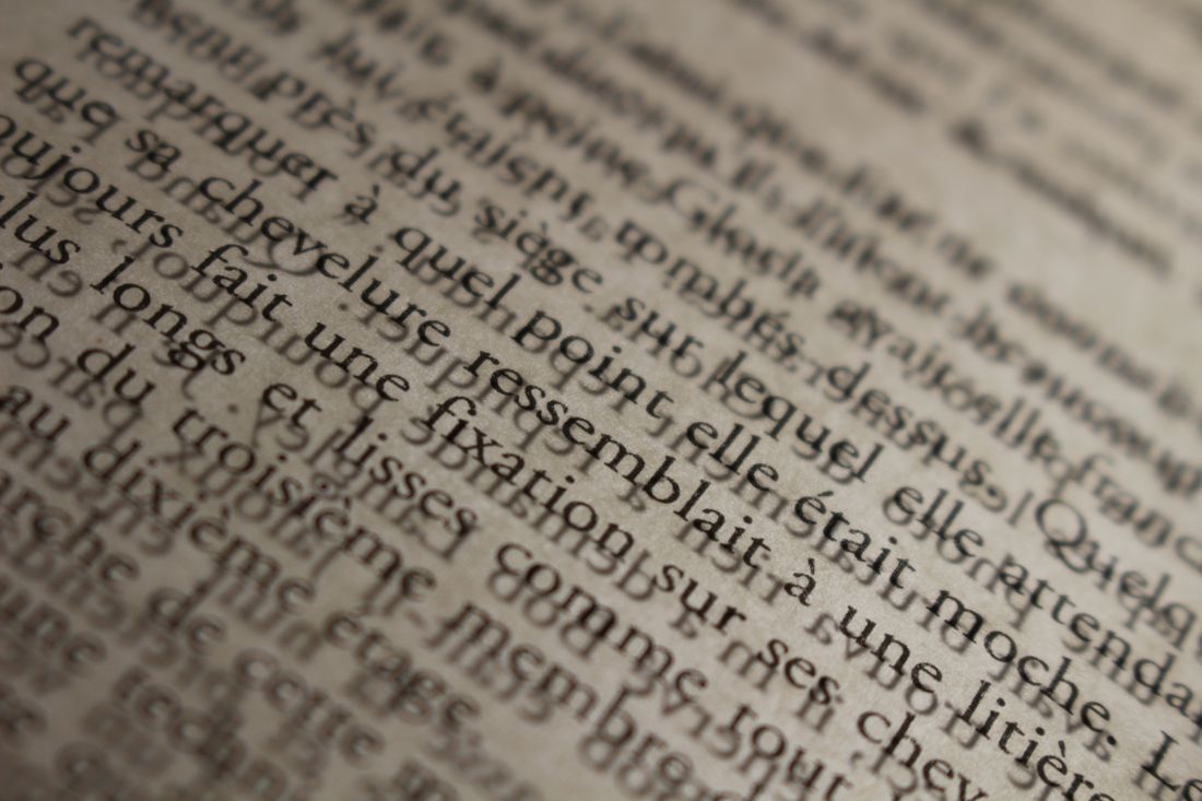 A macro shot of a printed page showing French-language text, no people or screens in frame.