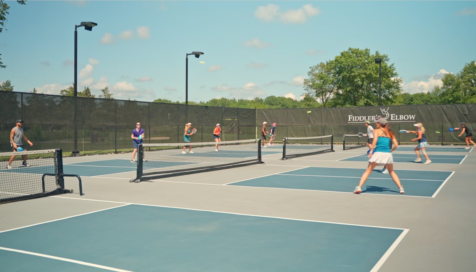 Pickleball courts with players in action.